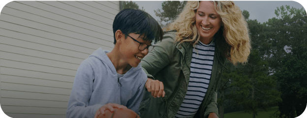 Person living with beta thalassemia and their caregiver playing basketball